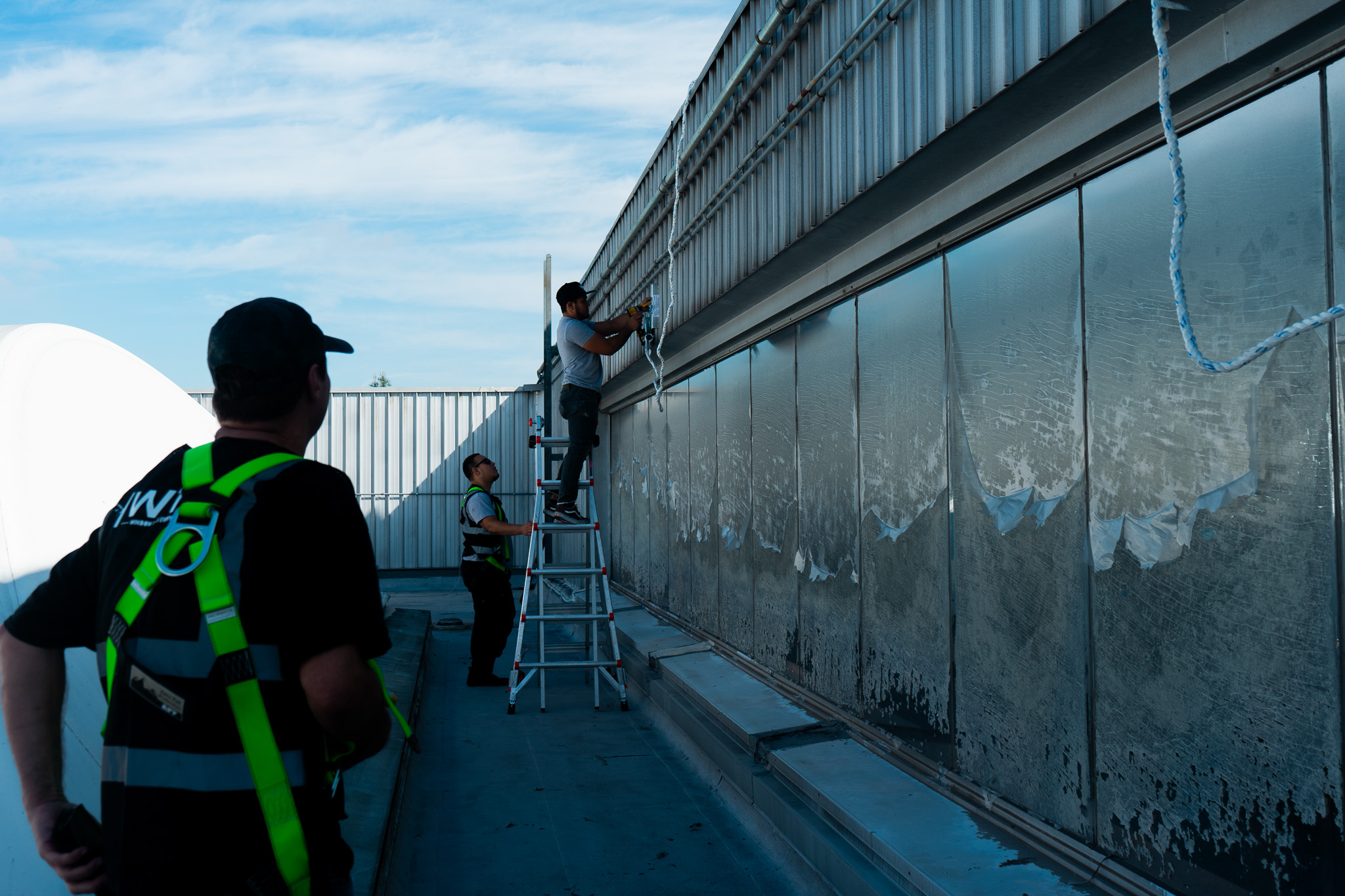 Professional solar film installation on large glass panels in Southern California